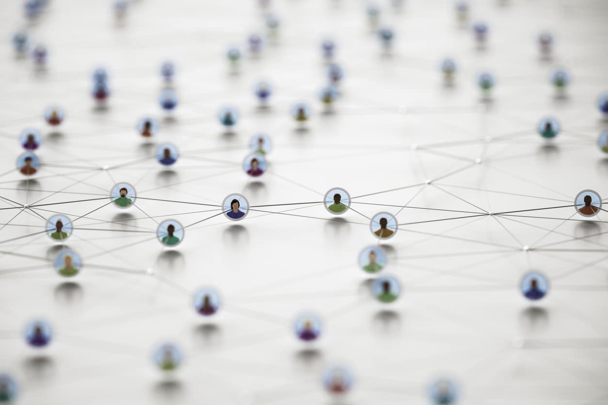An illustration of a network of diverse people connected by colorful wires on a white background. This image could represent a metaphor for a social network or a business team working together. It could also be used to represent the concept of an "endeca replacement," a new technology that is replacing an older, outdated system.