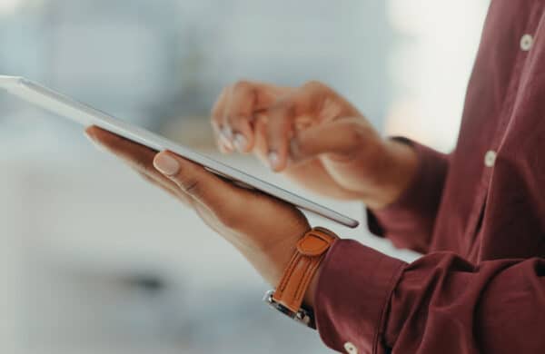 Man in office using tablet with generative AI-powered search results.