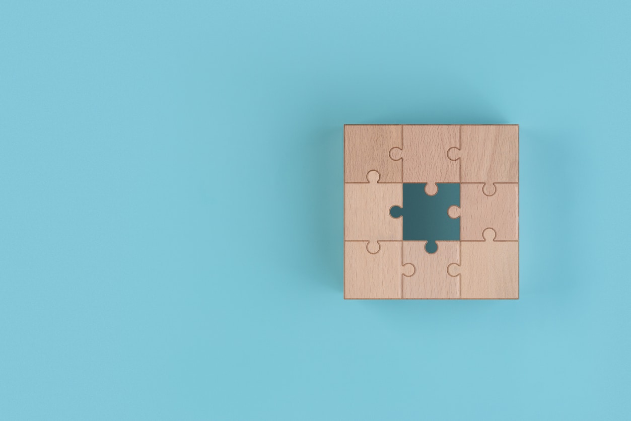 precise keyword matching representation of knowledge management technology; Lost jigsaw ,Filling in what is lacking ,Wooden blocks on a blue background ,Not completing the goal ,Copy space. 