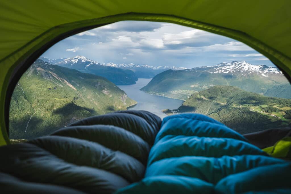 Sleeping bags inside tent in front of fjord in Sunnmore, Norway.