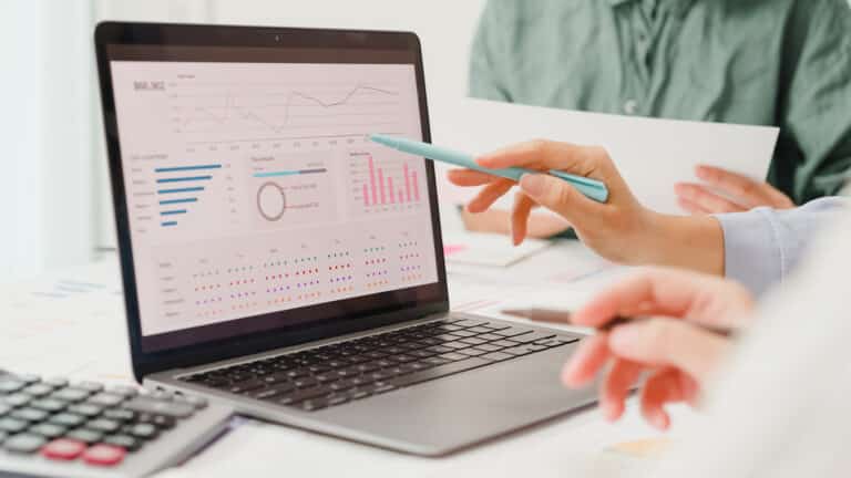 A laptop screen displays a data visualization with numbers and figures representing B2B customers' search behavior. The image illustrates the process of analyzing search data to optimize customer experience (CX) and increase sales in the B2B commerce sector. pen_spark tune share more_vert