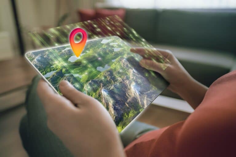 A person holds a tablet displaying a detailed 3D map with an orange location pin hovering above a lush green landscape. The map appears to be augmented reality, with light and particles emanating from the screen, representing AI search in the hospitality industry.