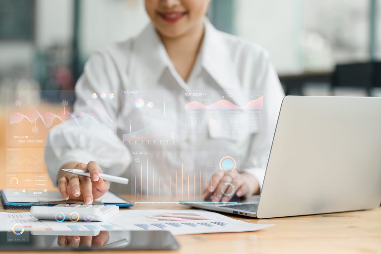 Business Analyst Reviewing Data Visualization on Screen Representing Customer Experience Trends