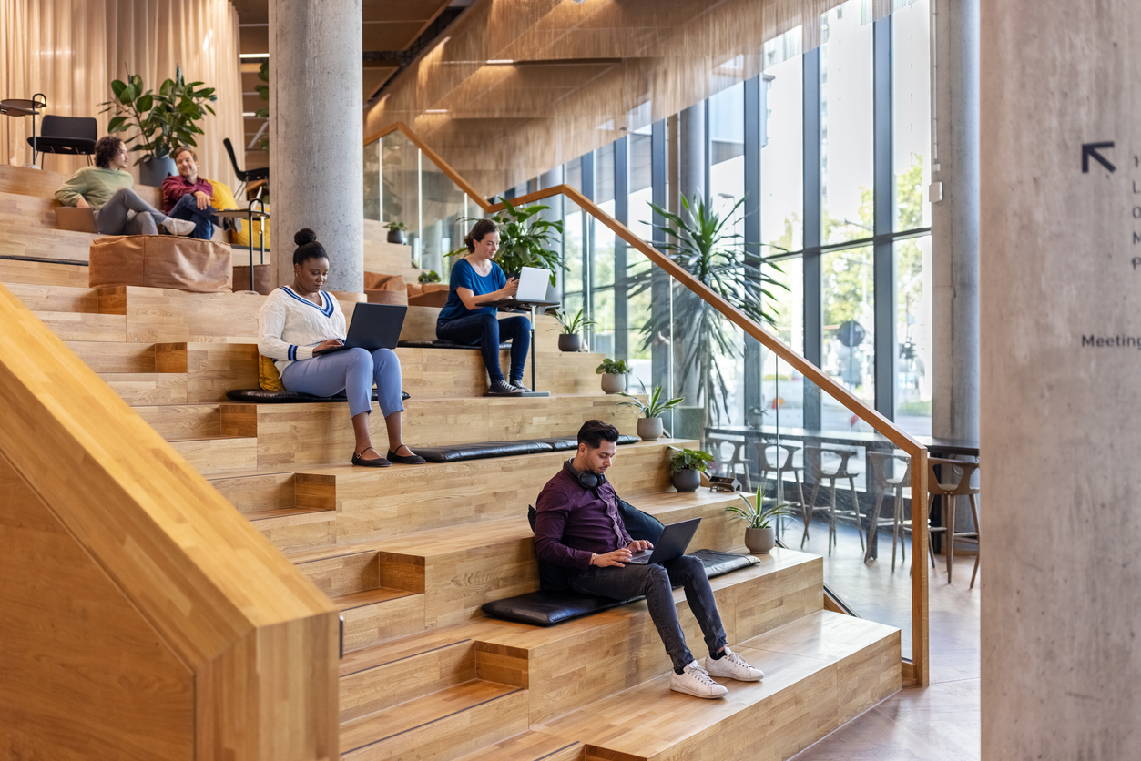 Group of business people sitting on steps, representing the 4 levels of agentic AI framework discussed in this blog.